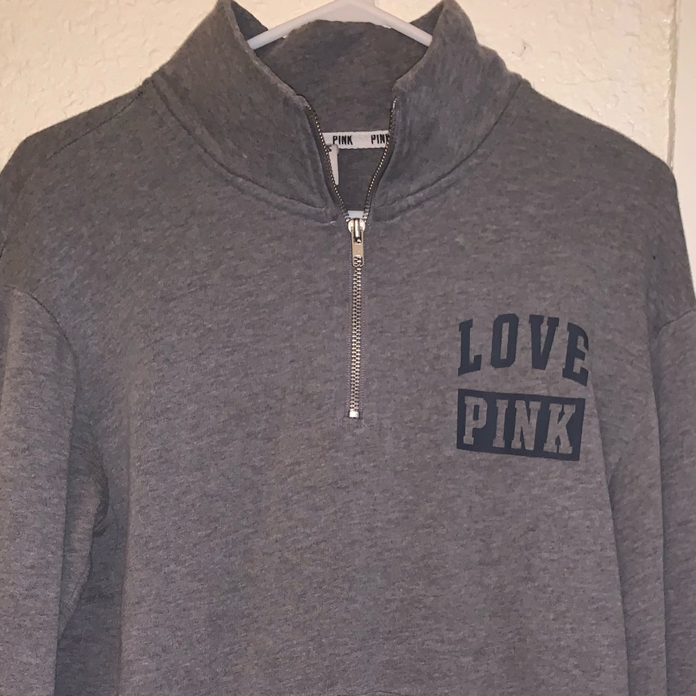 woman’s pink quarter zip up